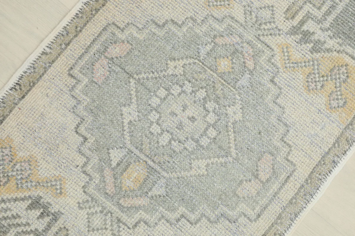 Overhead view focusing on the central gray geometric medallion and surrounding motifs.