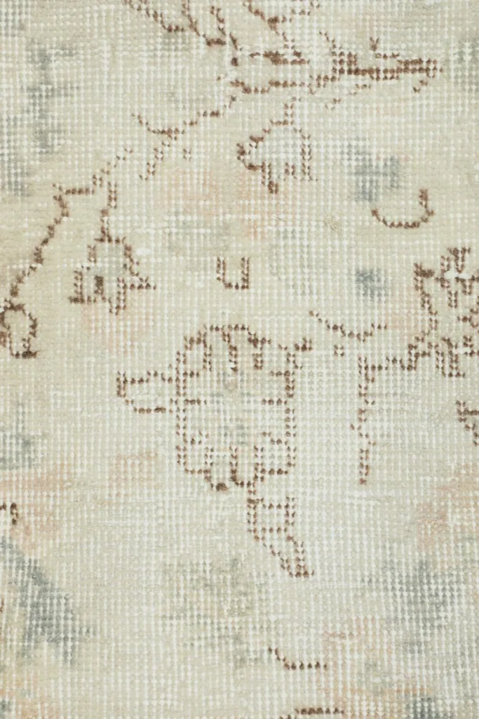 Detailed view of the low wool pile and hand-knotted texture, revealing the weave and subtle patterns