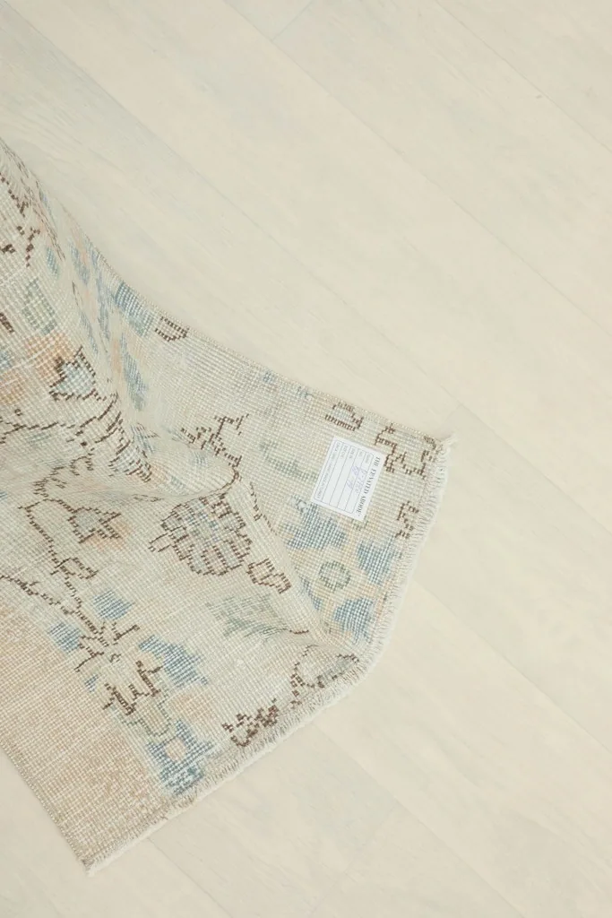 Underside view of the rug, revealing the woven cotton foundation and the craftsmanship of the knots