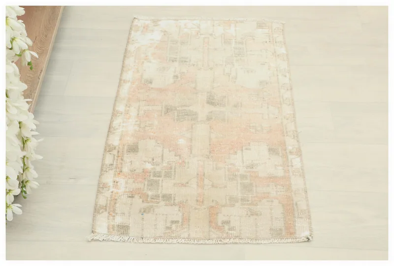 Full top view of the distressed beige geometric doormat on a white background