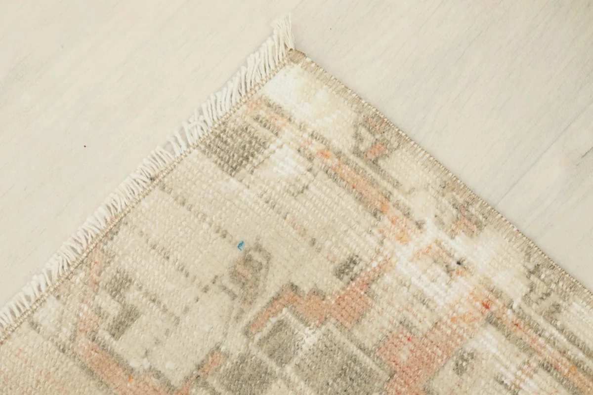 Corner view of the doormat, revealing the texture and the hand-knotted construction