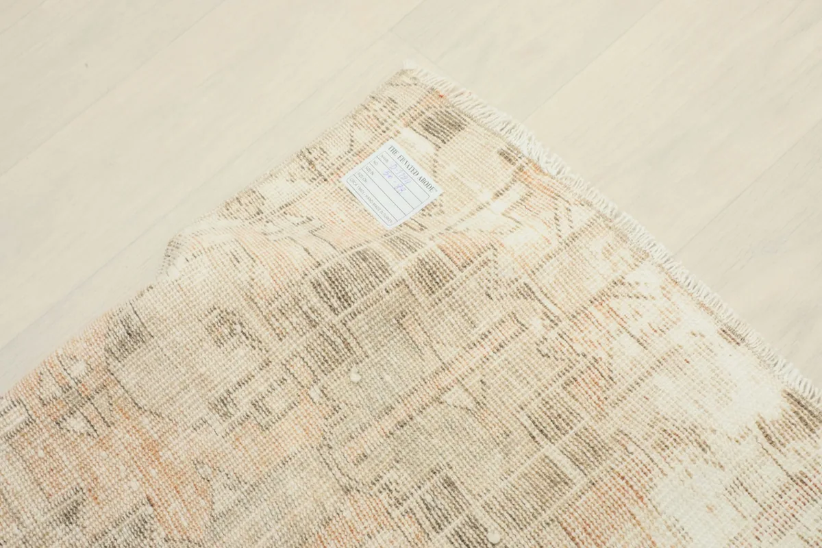 View of the back of the rug, showcasing the hand-knotted cotton foundation and weave