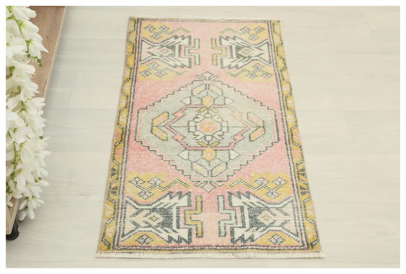 Full top view of the 1'7" x 3'1" vintage Anatolian doormat on a white background