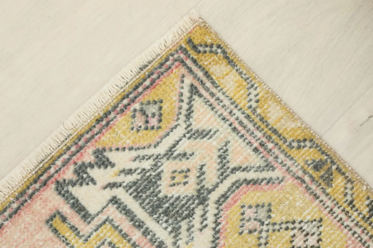 Corner view highlighting the yellow border and the texture of the low wool pile
