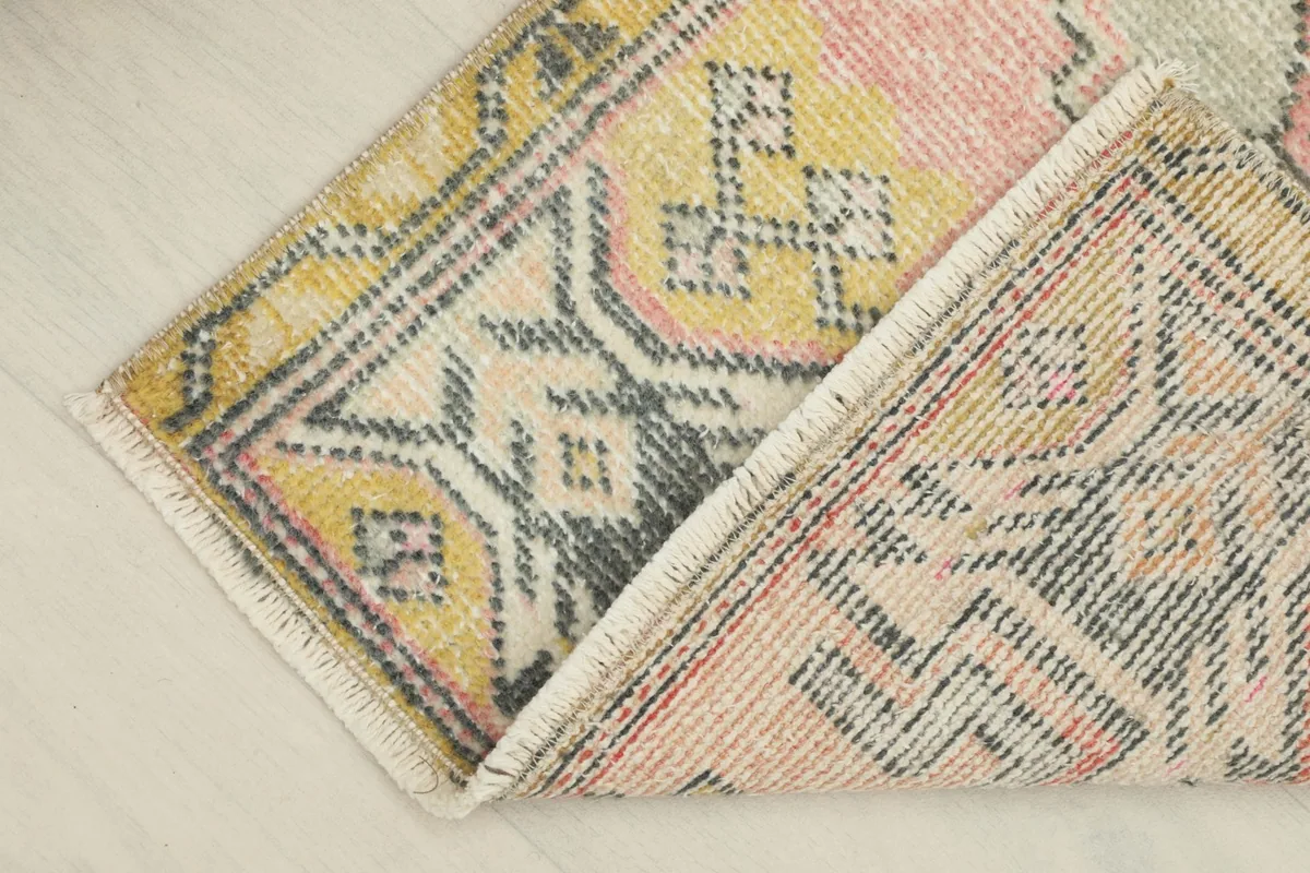 Folded corner showing the wool pile on cotton foundation and the reverse side of the rug