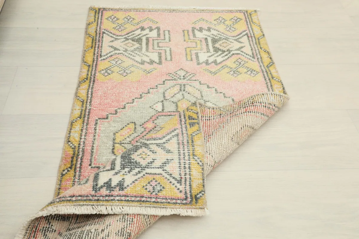 Partial fold of the rug revealing the back weave and the front design simultaneously