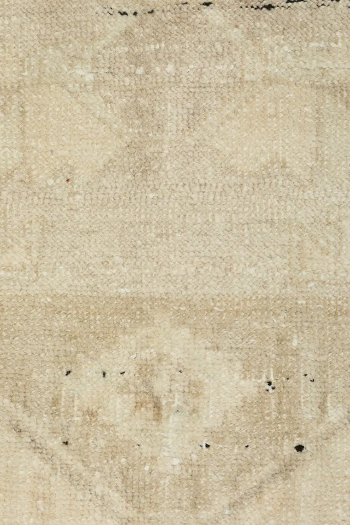 Detailed view of the rug's surface, revealing the texture of the low wool pile and subtle color shifts.