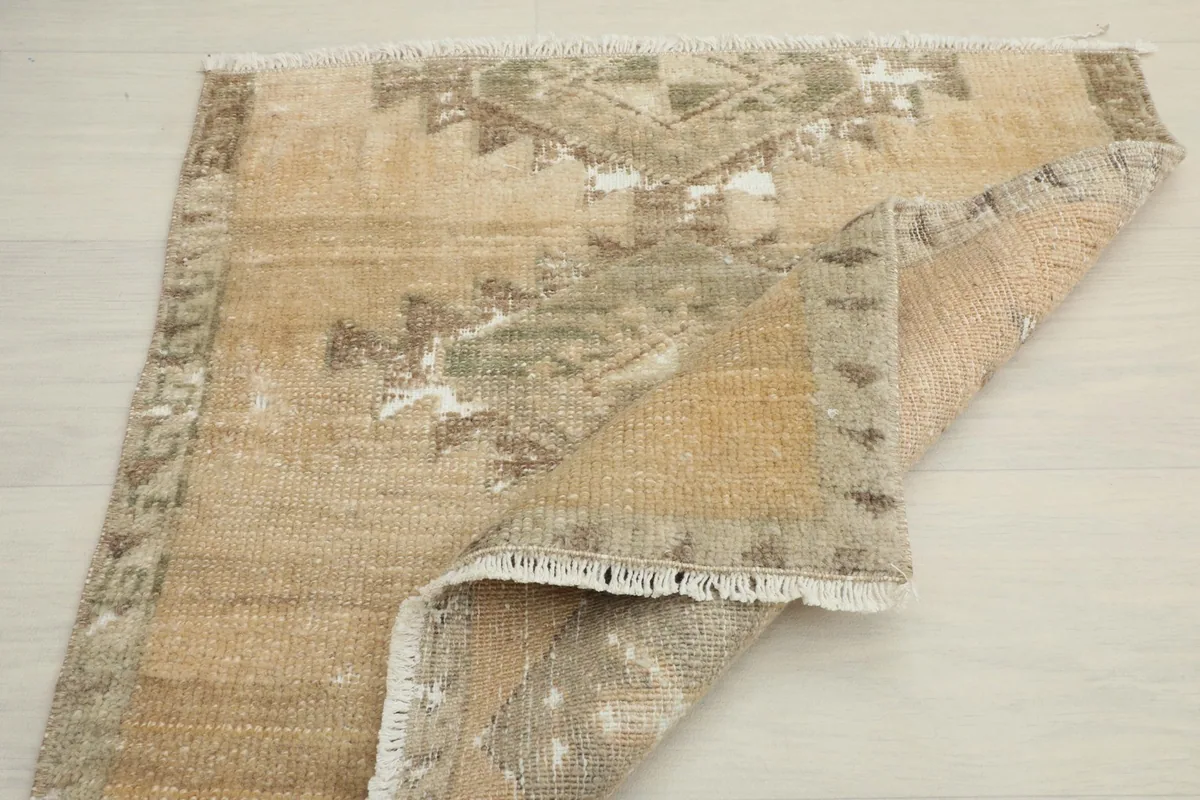 The rug partially folded, displaying its flexibility and the texture of the wool pile.