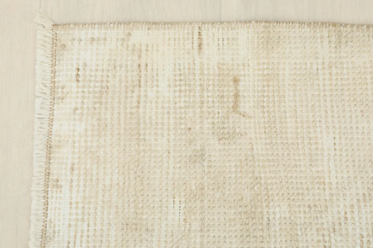 Close-up of another corner, highlighting the hand-knotted construction and soft fringe.