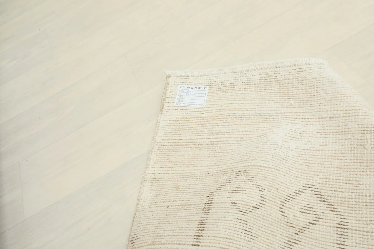 Close-up of the back of the rug, detailing the tight knots and cotton foundation.