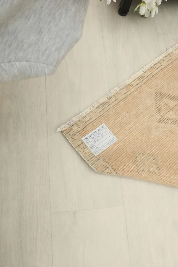 Close-up of the rug's label, providing information about its origin and materials.