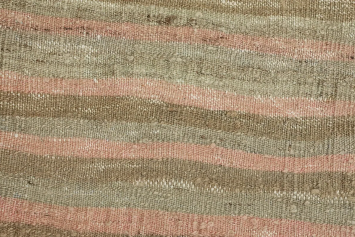 Detailed view of the wool pile and cotton foundation, revealing the hand-knotted texture and color blending.