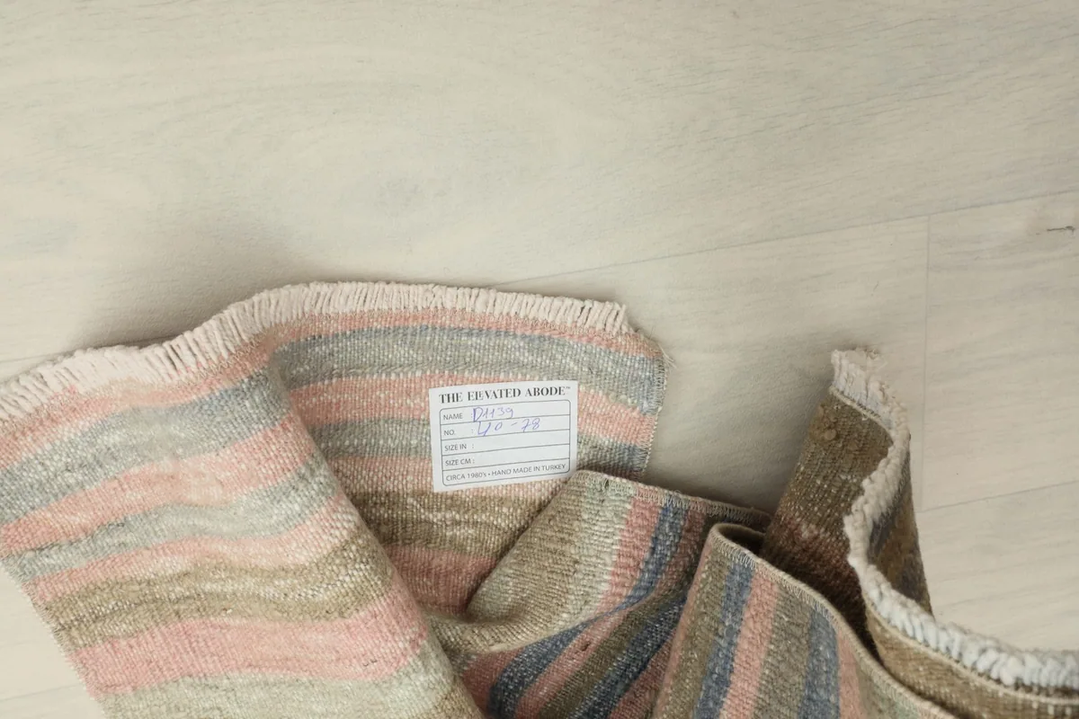 Close-up of the rug's back, including the brand label and the tightly woven cotton foundation.