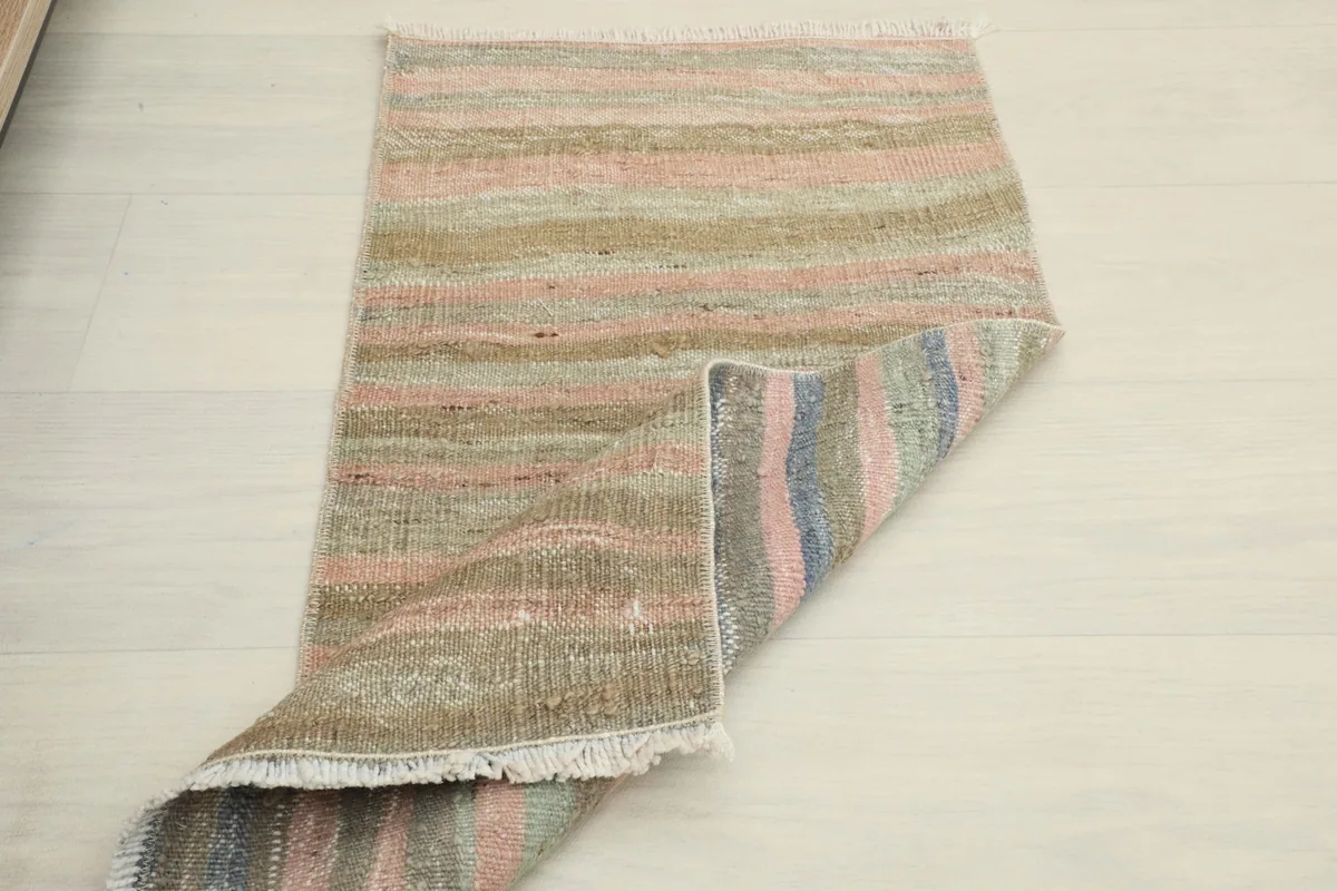The rug partially folded, displaying both the top surface and a glimpse of the back.