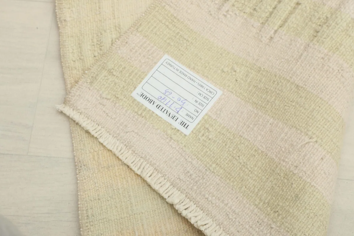 Close-up of the back of the rug, showcasing the hand-knotted cotton foundation.