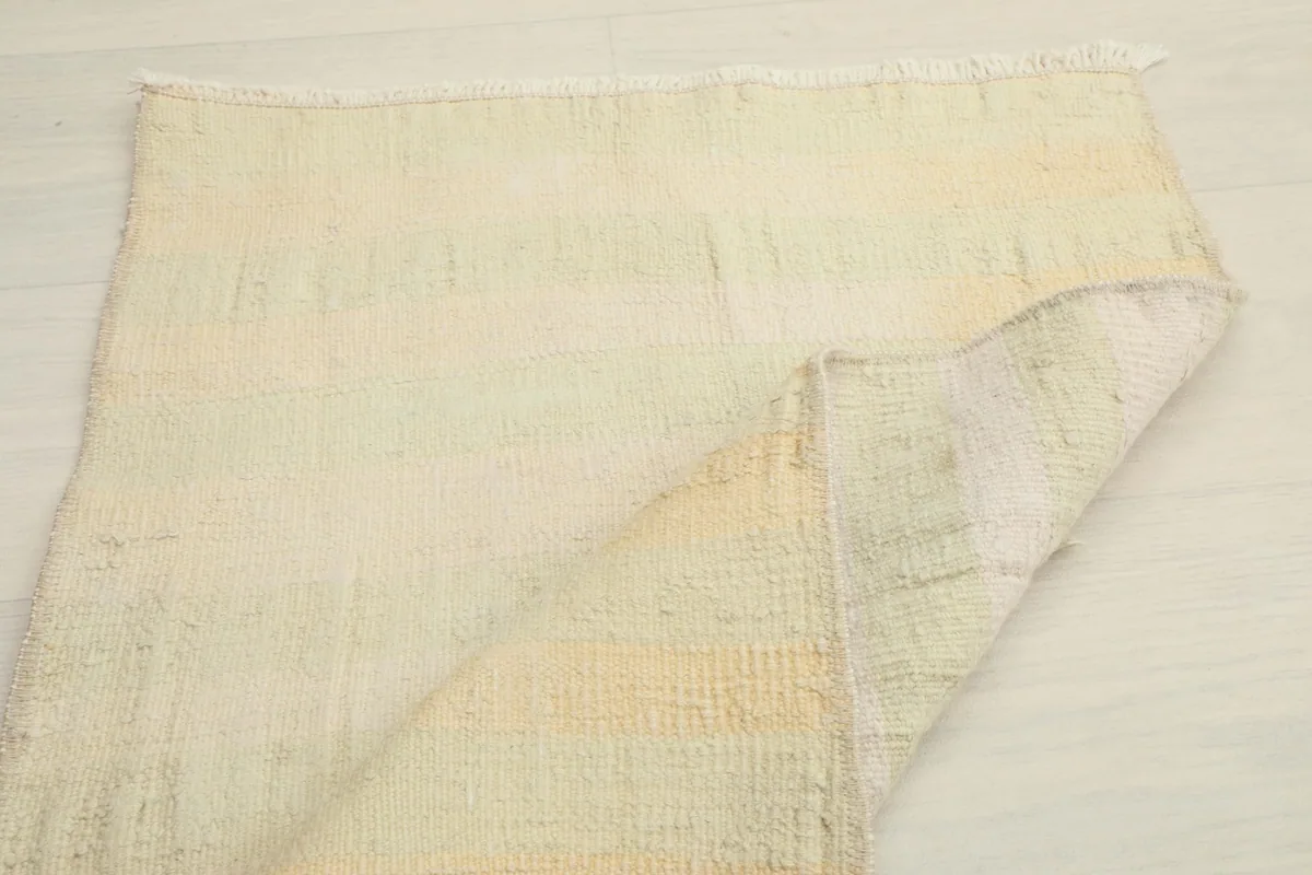 Another view of the rug partially folded, emphasizing its flexibility and construction.