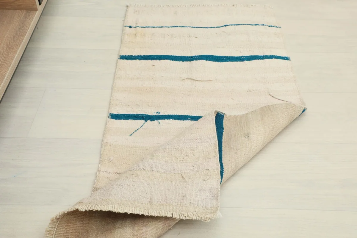 Another perspective of the rug folded, showing the thickness and the back of the weave.
