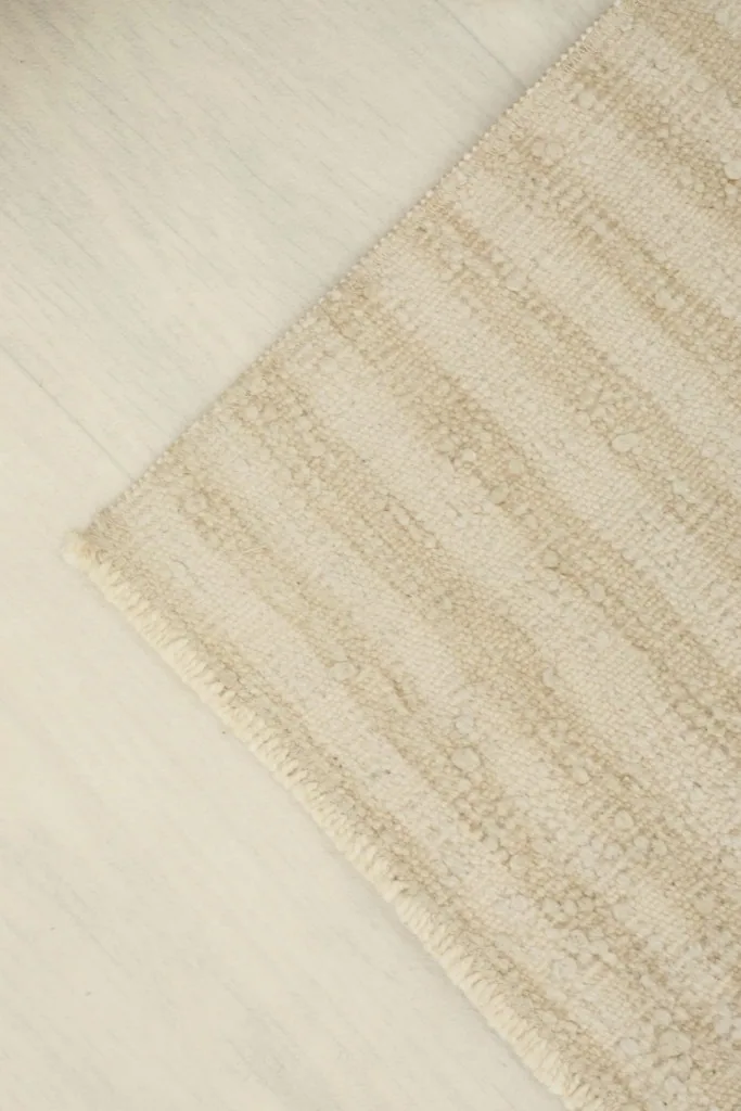 Overhead angled view of the doormat, emphasizing the natural beige and tan color variations.