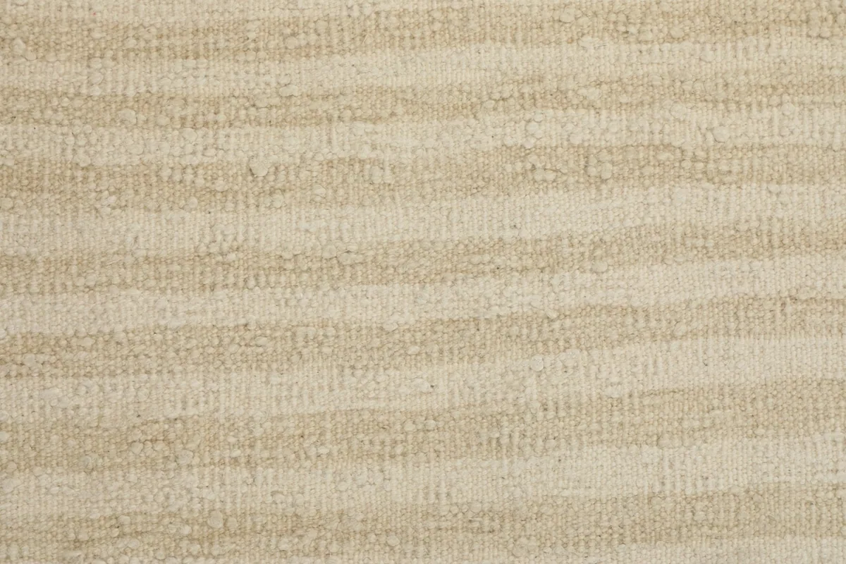 Direct close-up of the low wool pile, revealing the organic stripe pattern and texture.