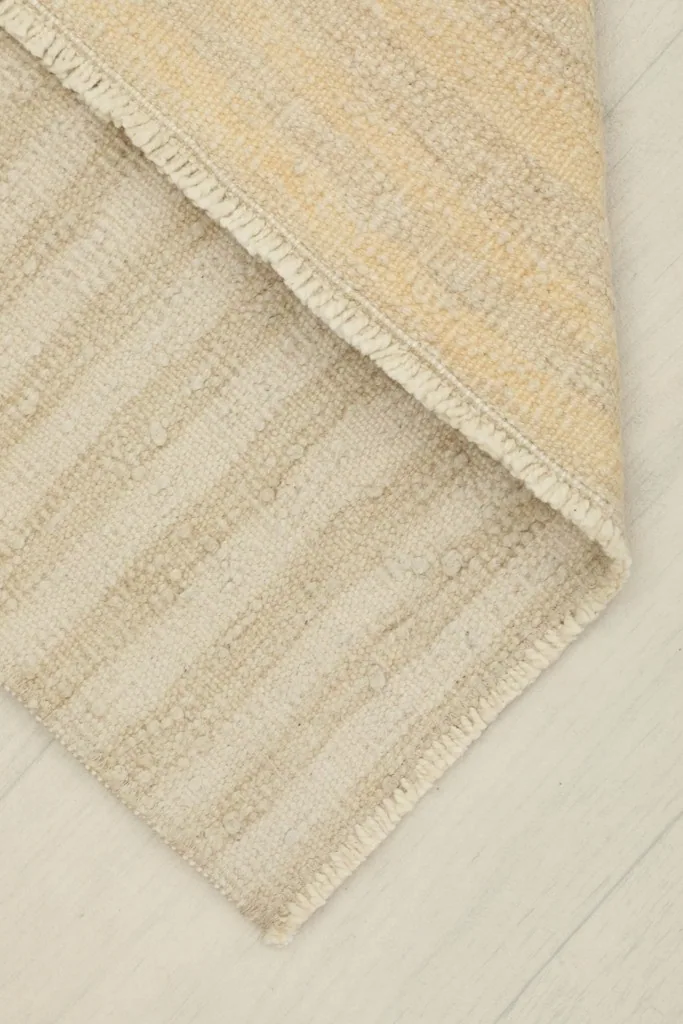 View of the back of the hand-knotted rug, revealing the cotton foundation and construction.