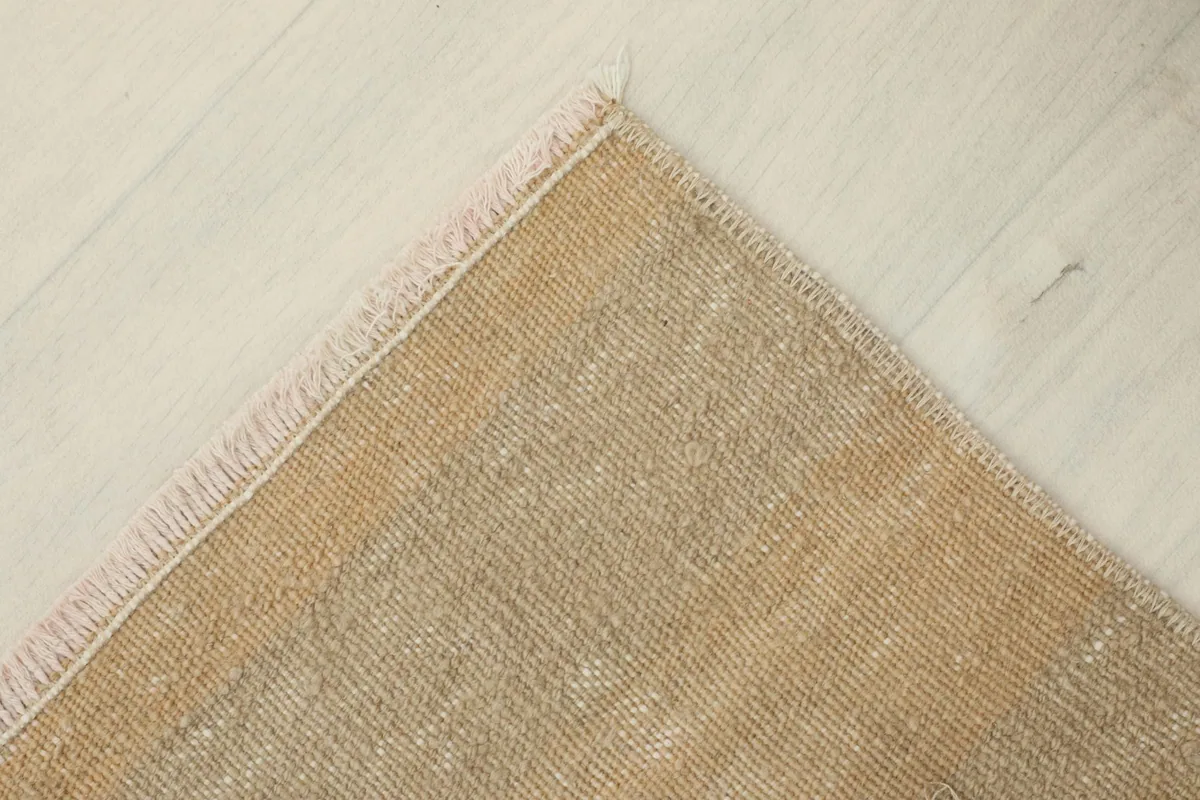 Close-up of the rug's reverse side, highlighting the hand-knotted construction and cotton foundation.