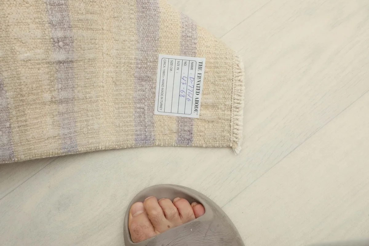 Overhead view with a foot in a sandal, providing a sense of scale for the 1'5" x 2'3" doormat.