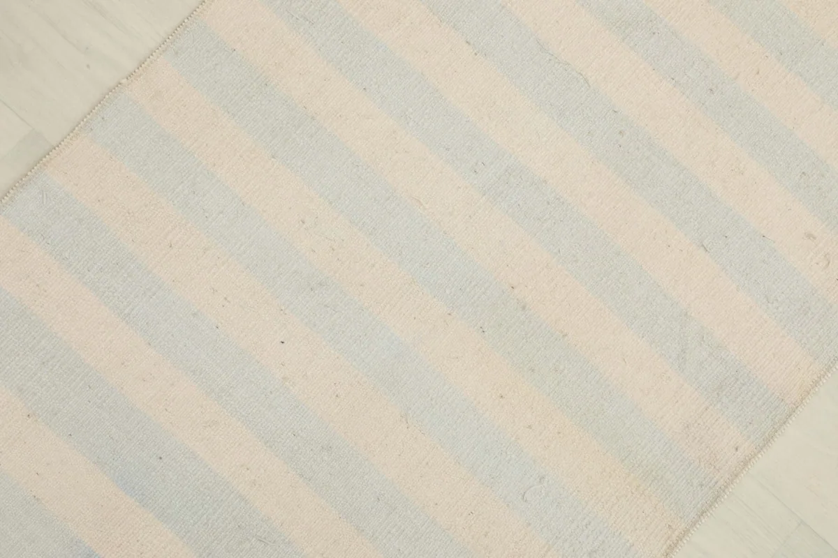 Overhead view of the striped pattern, showing the cream and blue color variation.
