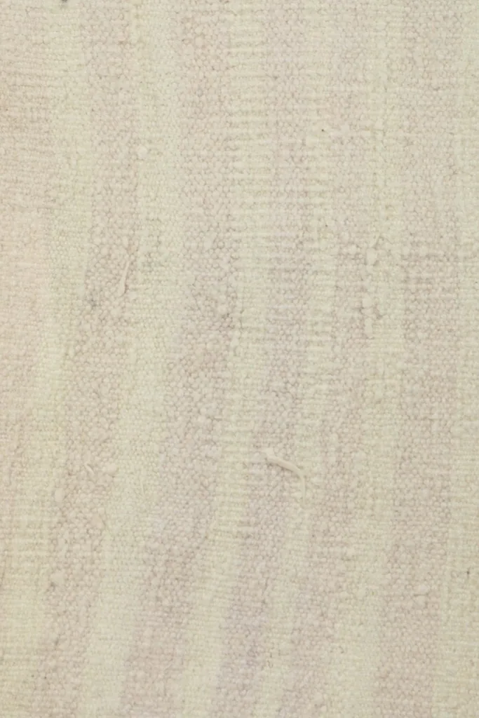Detailed view of the low wool pile, showing the subtle color variations and hand-knotted texture