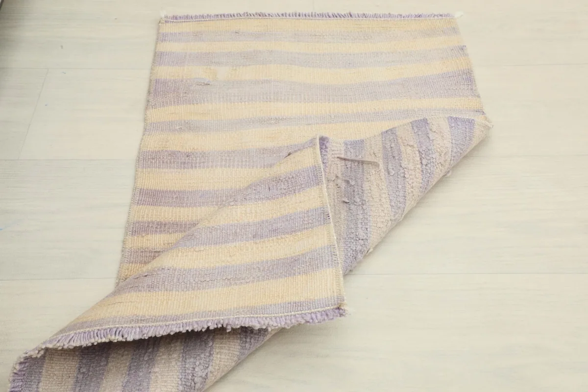 The rug partially folded, illustrating its flexibility and the texture of both the front and back.