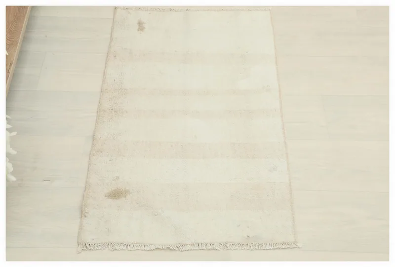 Full top view of the 1'7" x 2'10" beige and ivory striped vintage Anatolian rug on a white background.