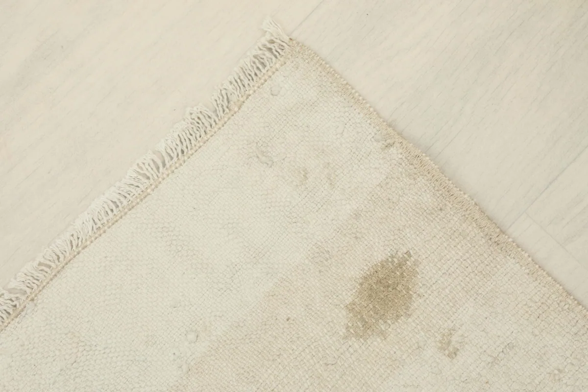 View of the rug's back, revealing the hand-knotted construction and cotton foundation.