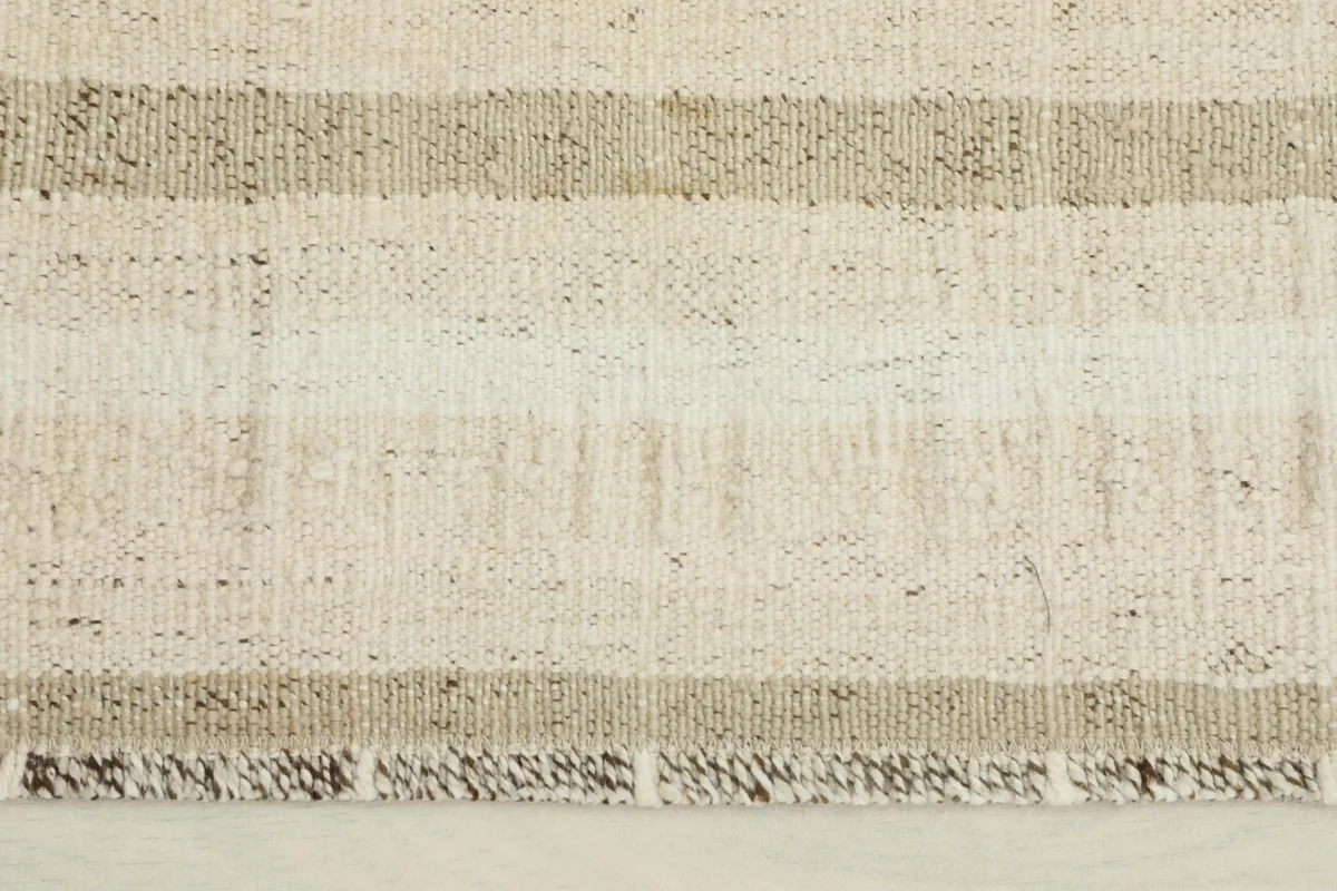 Close-up detail of the woven texture and gray stripes on the vintage wool rug