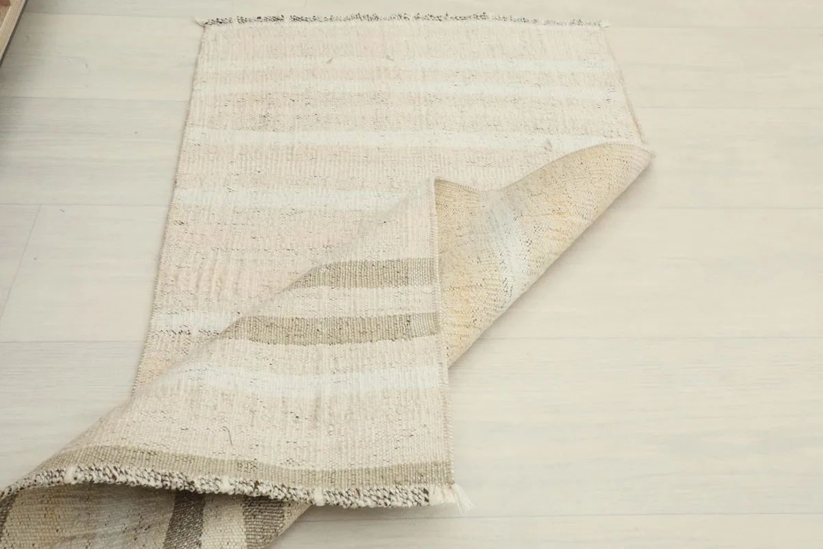 The rug partially folded, showcasing its flexibility and the reverse side