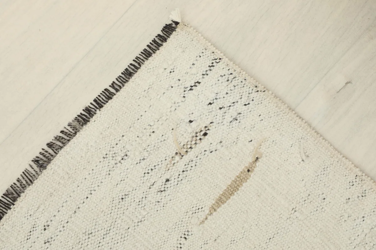 Angled view of the rug's corner, emphasizing the texture and construction.