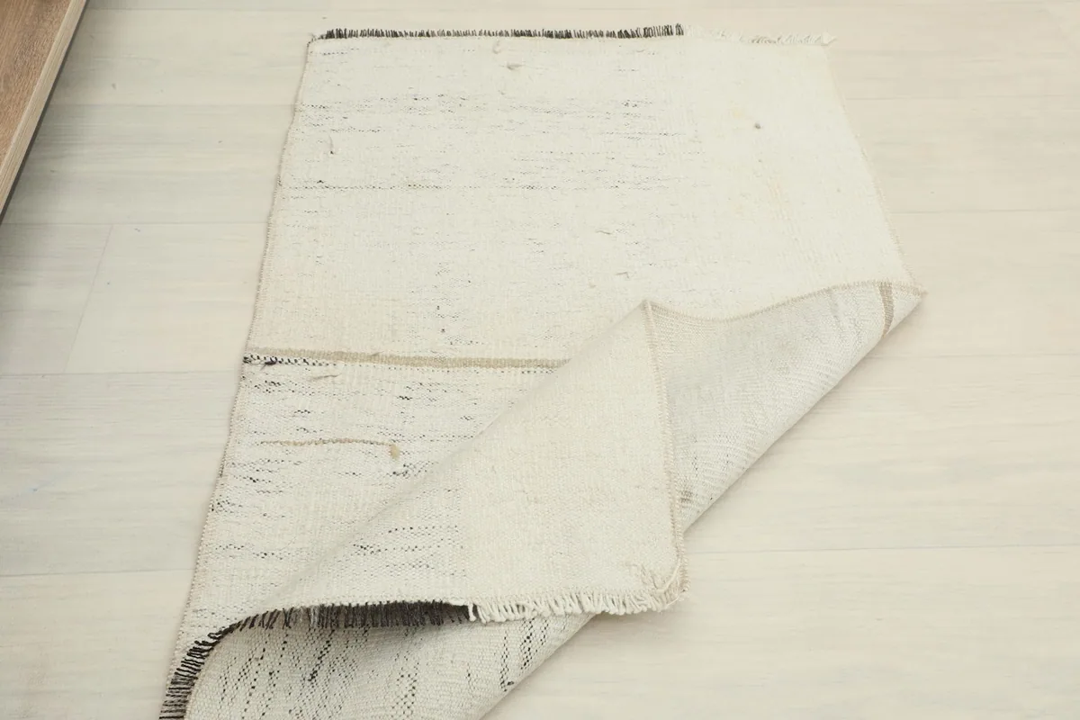 Another view of the rug folded, showing the soft drape of the vintage wool.