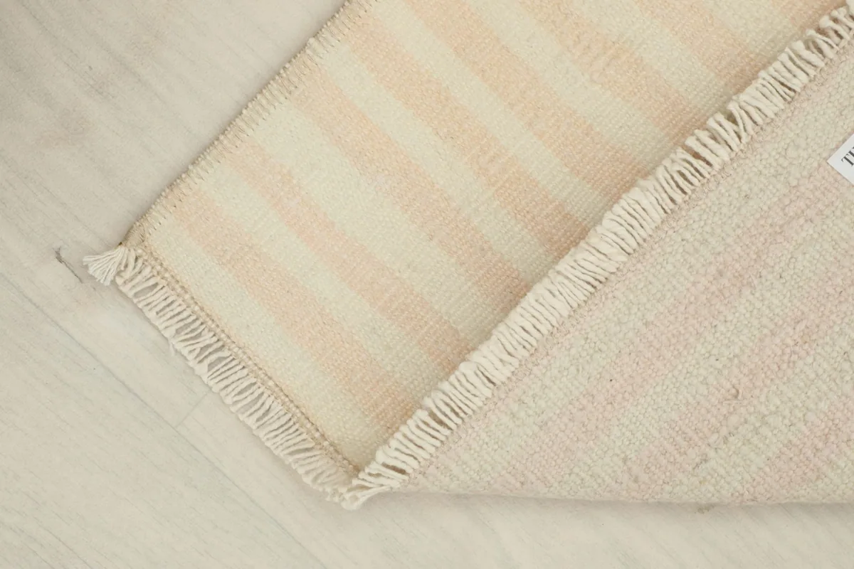 View showing the reverse side of the rug, revealing the hand-knotted cotton foundation and wool pile.