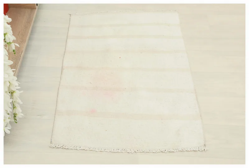 Full top view of the cream and beige striped vintage Anatolian rug on a white background.