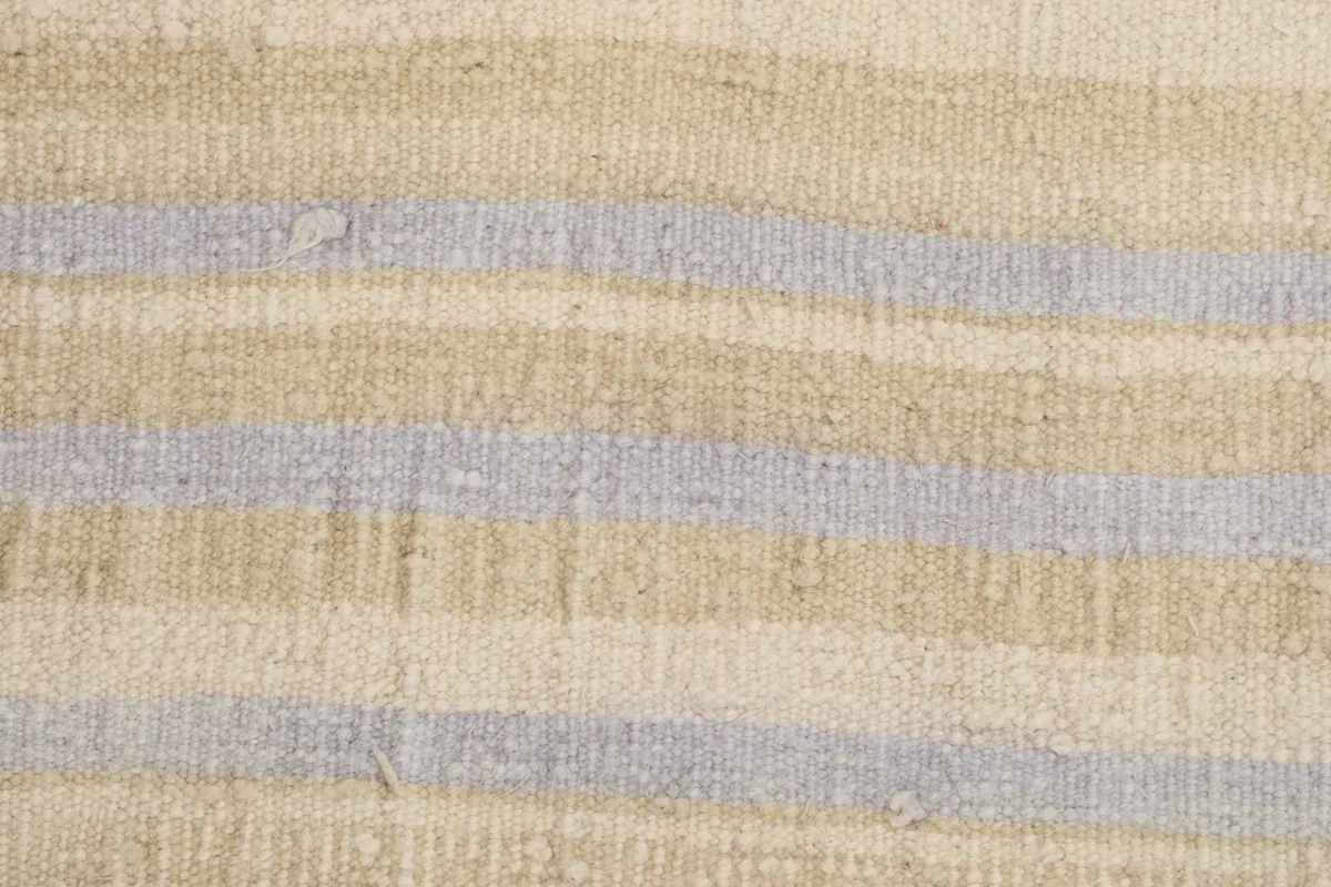 Detailed view of the wool pile, showing the distinct beige and purple stripes and subtle wear.