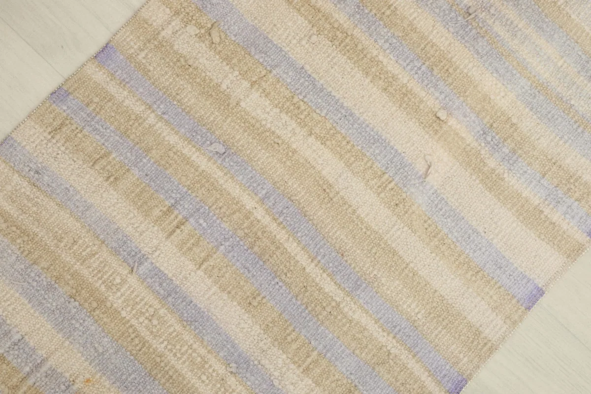 Overhead view of the rug, highlighting the varied texture and natural color shifts in the stripes.