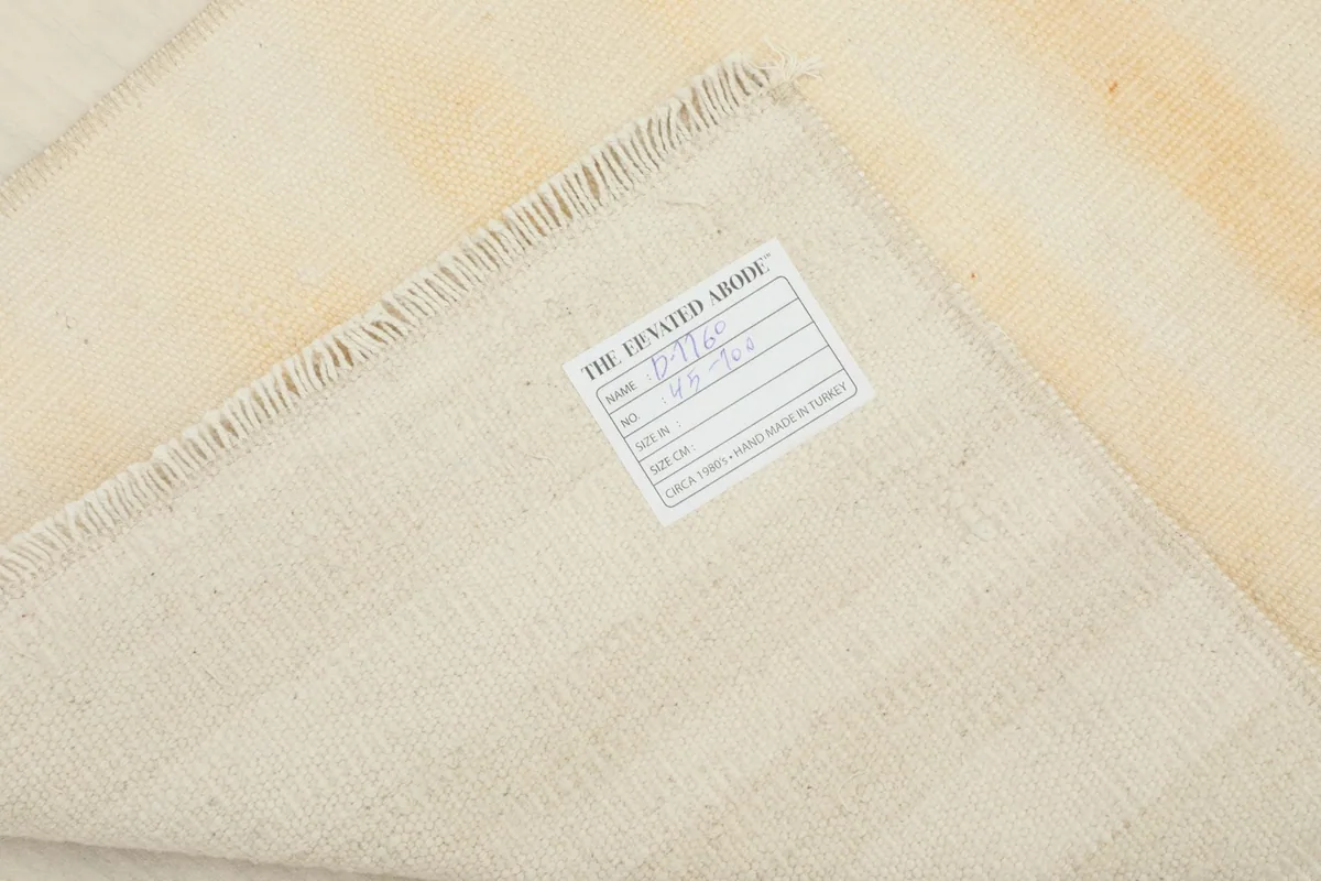 Close-up of the rug's reverse side, including the RugsKilim label confirming its origin and materials.