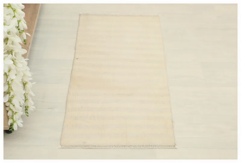 Full top view of the ivory and cream striped vintage Anatolian doormat