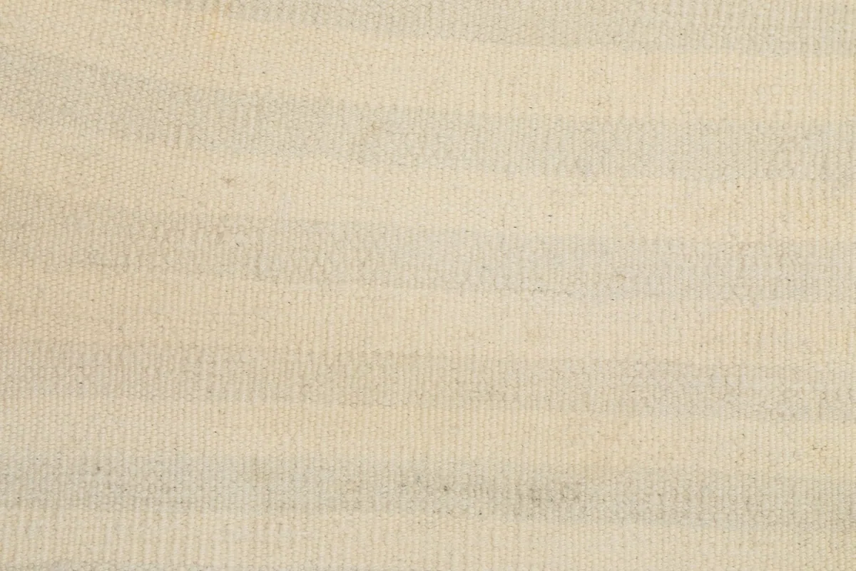 Detail of the low wool pile and hand-knotted texture of the rug