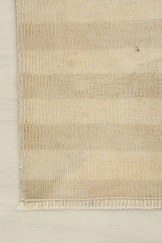 Close-up of the corner and the striped texture of the vintage Anatolian rug.