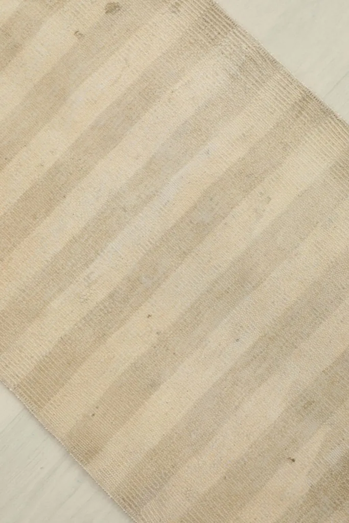 Overhead view showing the consistent striped pattern and natural color variations across the rug.
