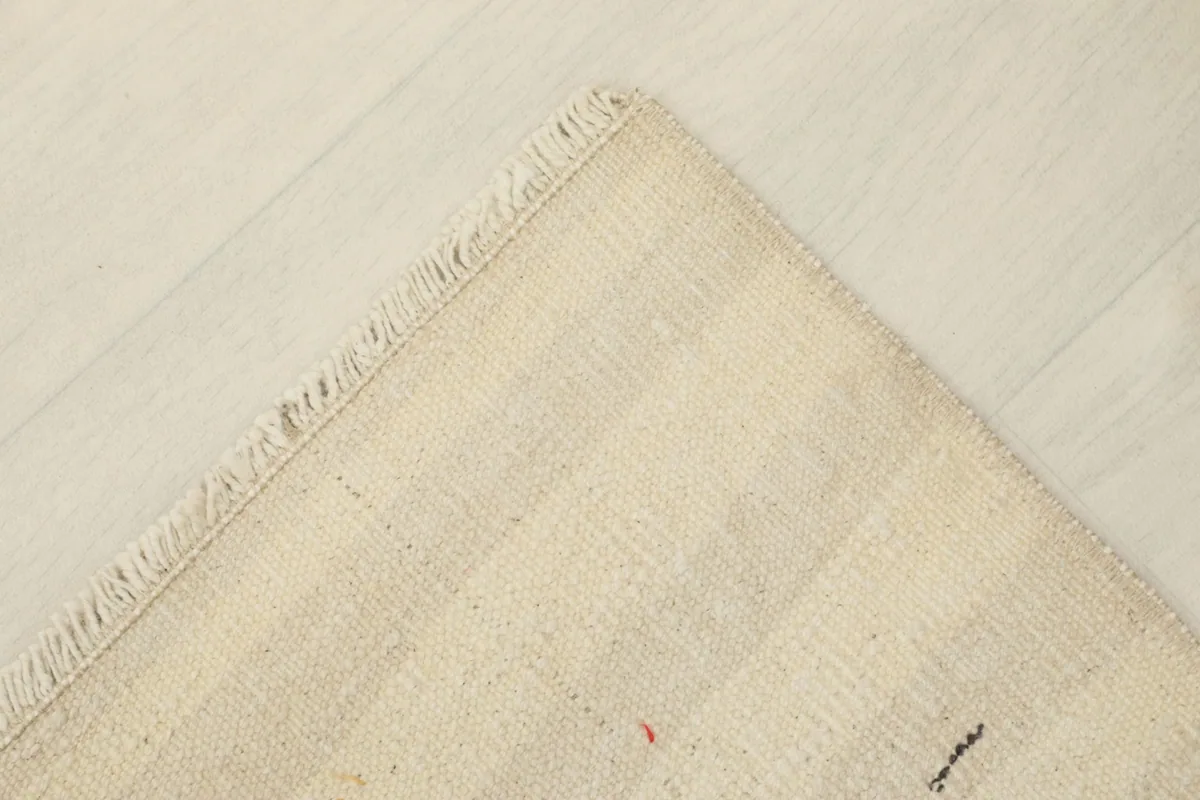 View of the back of the rug, revealing the cotton foundation and hand-knotted construction.