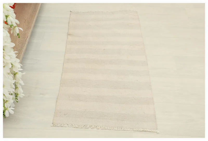 Full top view of the 1'5" x 2'11" beige striped vintage doormat