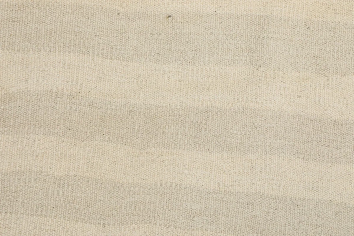 Tight detail of the varying beige and ivory tones in the striped wool pile