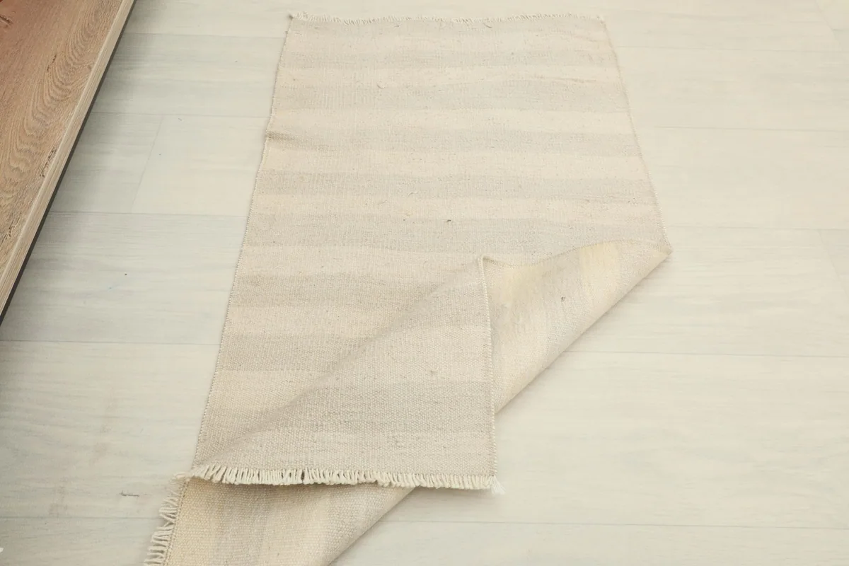 The rug partially folded, showing its flexibility and thickness