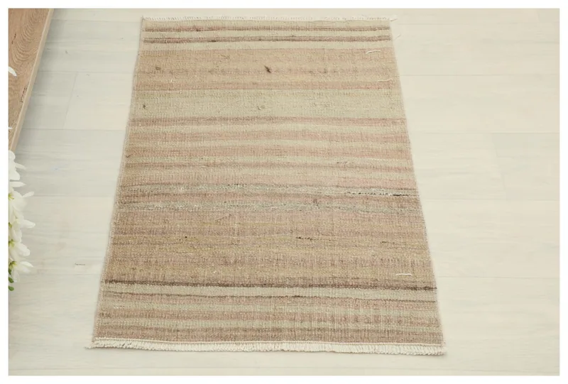 Full top view of the 1'7" x 2'7" beige and brown striped vintage Anatolian rug on a white background.