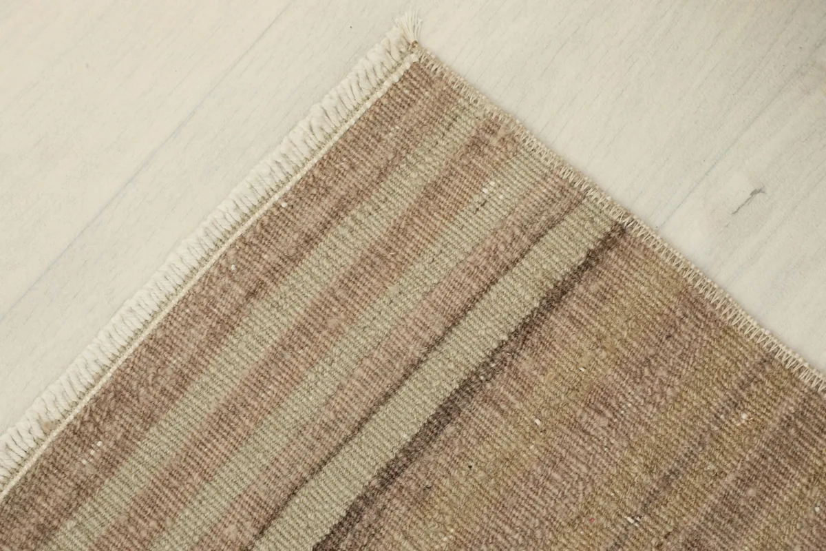 Another corner view, displaying the craftsmanship and the natural finish of the rug's fringe.